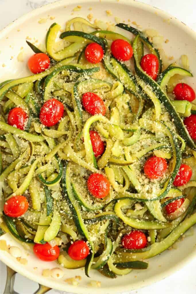 Overhead shot of caramelized zucchini pasta in skillet.