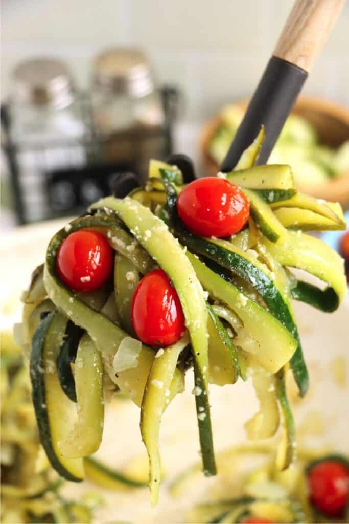 Closeup shot of spoonful of caramelized zucchini pasta. 