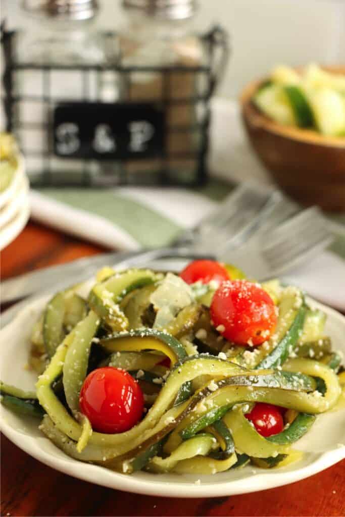 Closeup shot of caramelized zucchini pasta on plate.