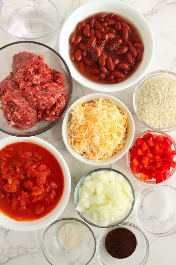 Overhead shot of individual southwestern beef and rice skillet ingredients in bowls on table