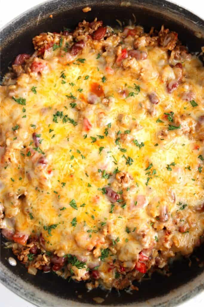 Overhead shot of cheesy southwestern beef and rice skillet in skillet. 