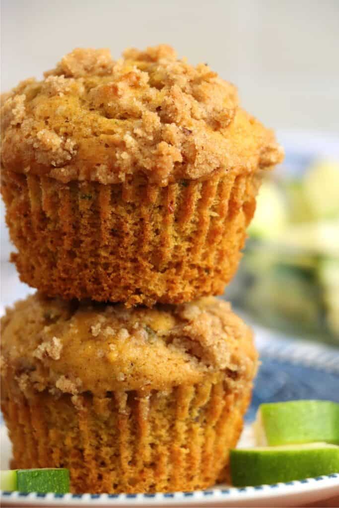 Closeup shot of two pumpkin zucchin muffins stacked atop one another. 