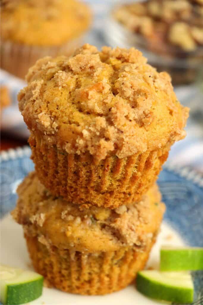 Closeup shot of two pumpkin zucchini muffins stacked atop one another. 