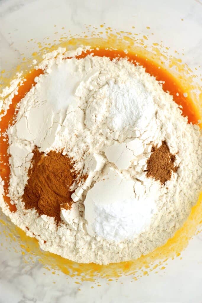 Overhead shot of all dry ingedients on top of mixed wet ingredients in mixing bowl. 