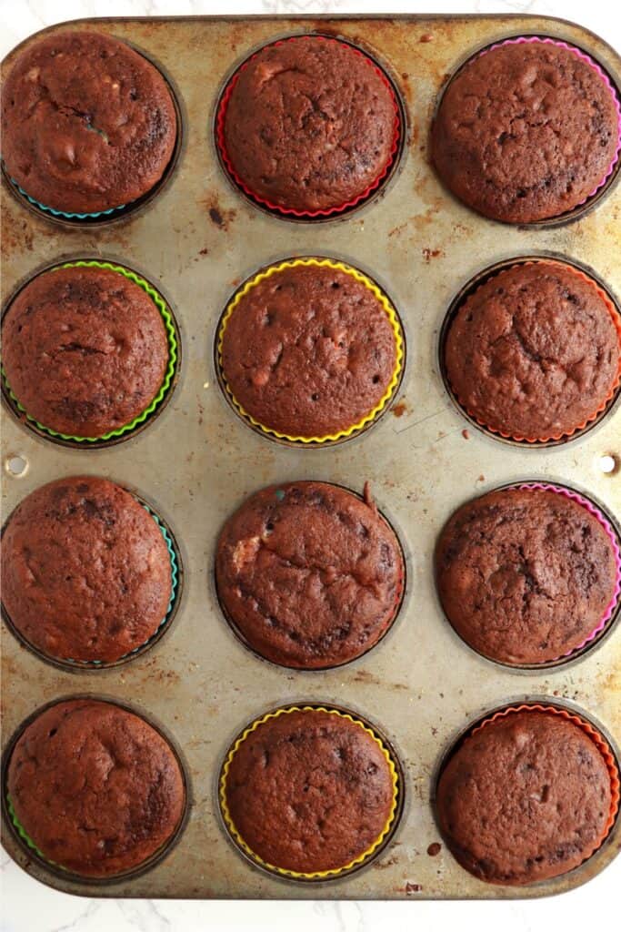 Overhead shot of baked cream cheese stuffed cupcakes in muffin tin