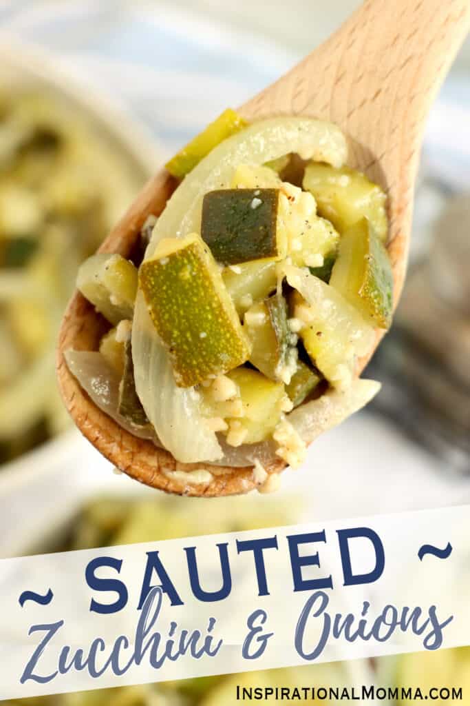 Overhead closeup shot of large wooden spoon full of sauteed zucchini and onions.