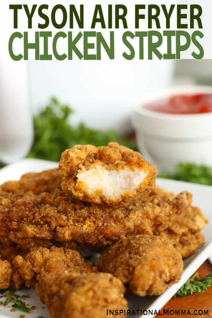 Closeup shot of air fryer Tyson chicken strips stacked atop on another with bite taken out of top chicken strip. 