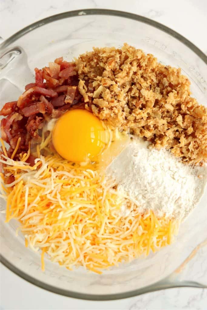 Overhead shot of mashed potato patties recipe ingredients in mixing bowl. 