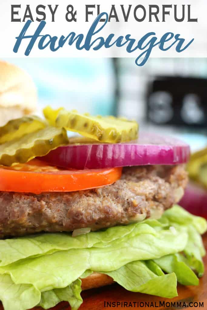 Closeup shot of classic American burger with lettuce, tomato, onion, and pickles.