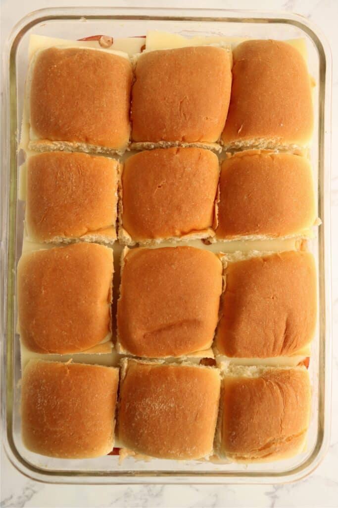 Overhead shot of unbaked corned beef sliders.