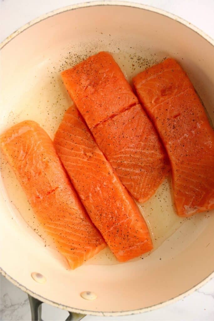 Overhead shot of salmon in skillet. 