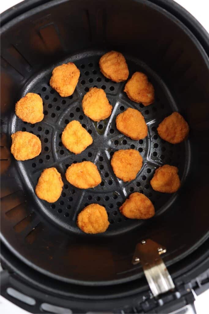 Overhead shot of cooked Tyson air fryer chicken nuggets in air fryer basket.
