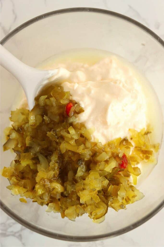 Overhead shot of mayo, lemon juice, and sweet relish in bowl