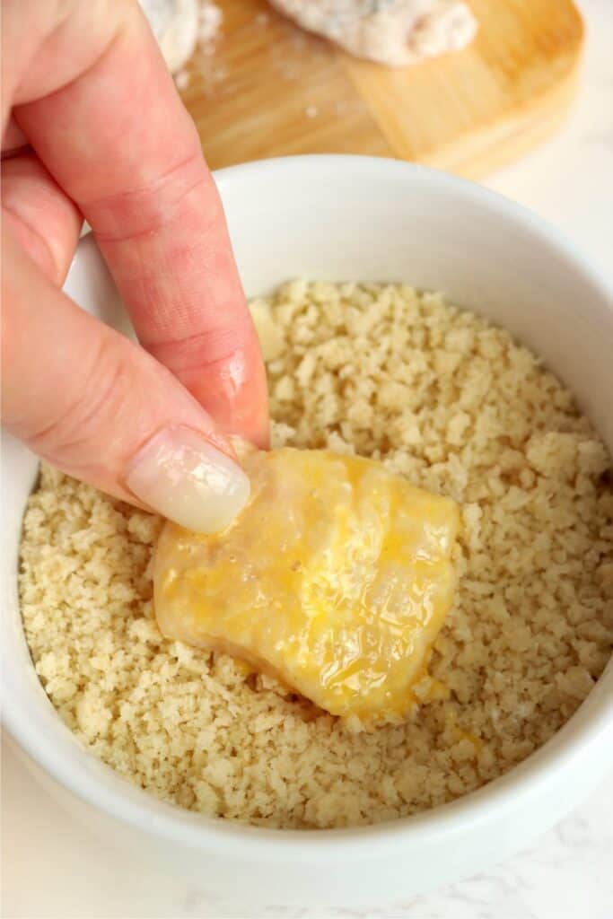 Closeup shot of catfish nugget being coated in panko. 