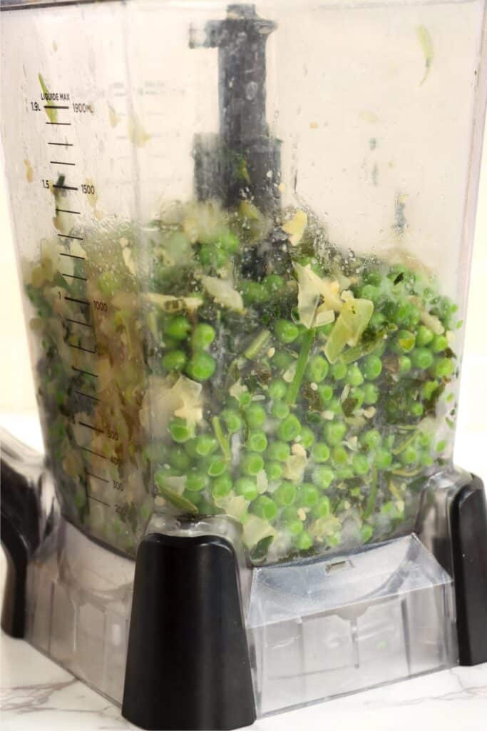 Closeup shot of blender full of vegetables. 