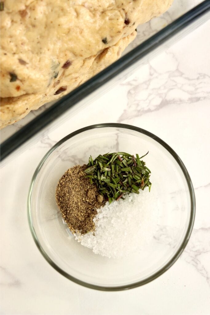 Closeup overhead shot of salt and herbs in small bowl