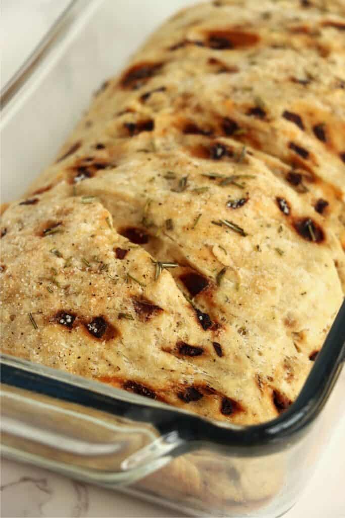 Closeup shot of baked sage bread with onion in loaf pan