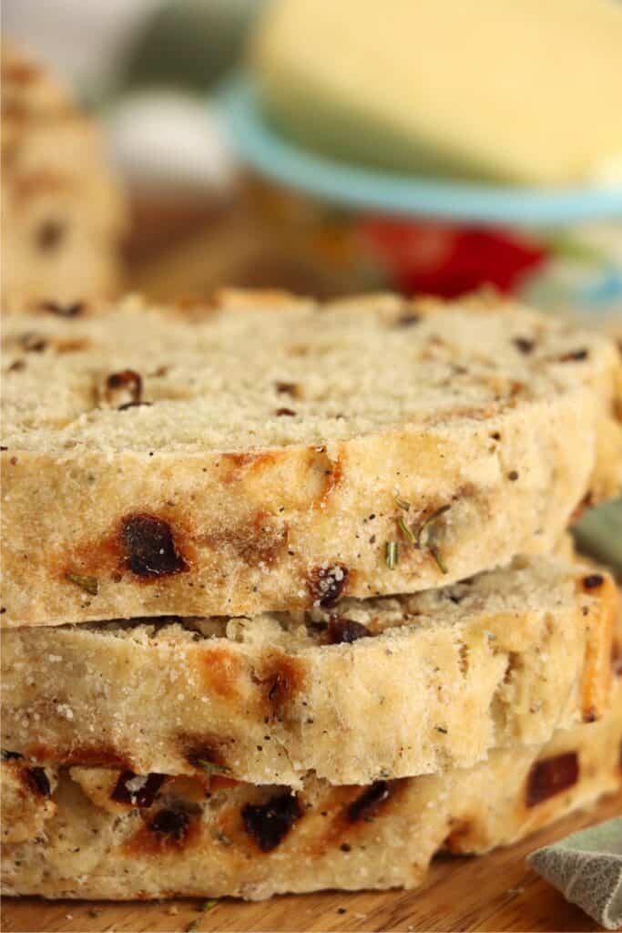 Closeup shot of three slices of onion sage bread stacked atop one another.