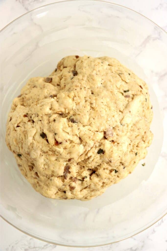 Overhead shot of sage bread dough in bowl.