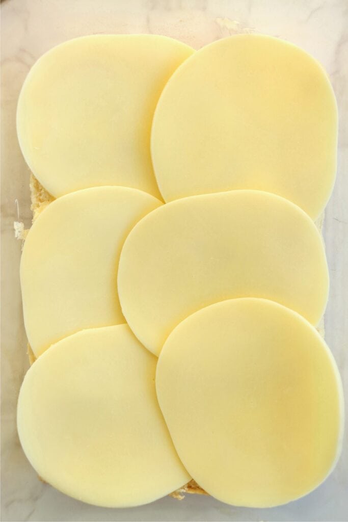 Overhead shot of rolls topped with cheese.