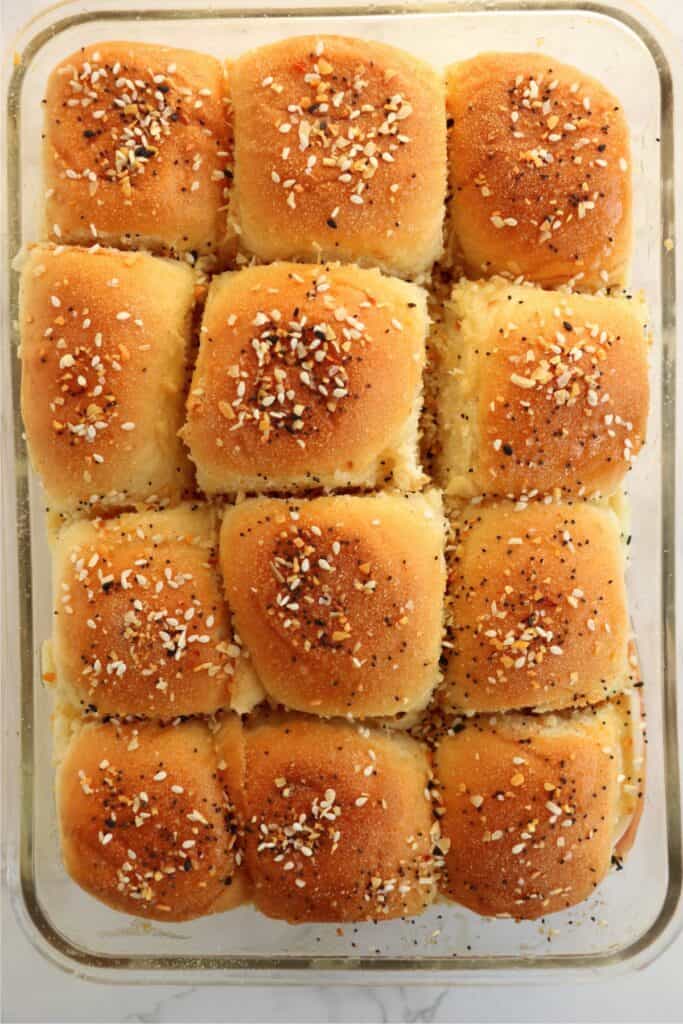 Overhead shot of turkey sliders topped with melted butter and Everything seasoning.