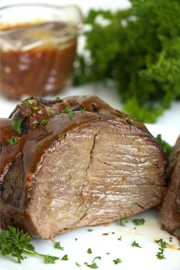 Closeup shot of Vietnamese pot roast cut in half on plate