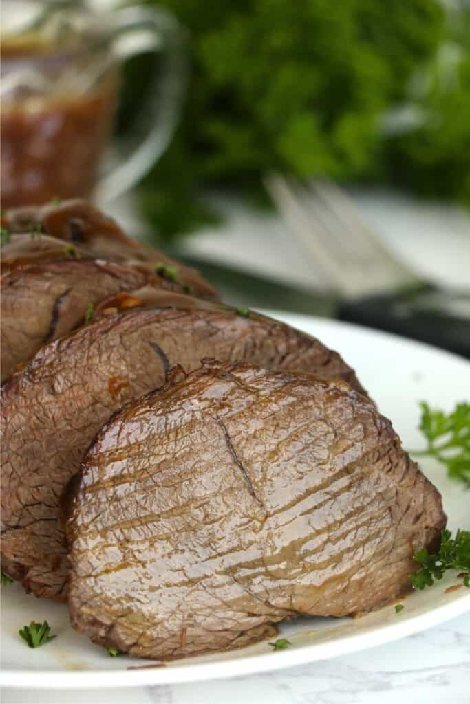 Closeup shot of sliced Vietnamese pot roast on plate.