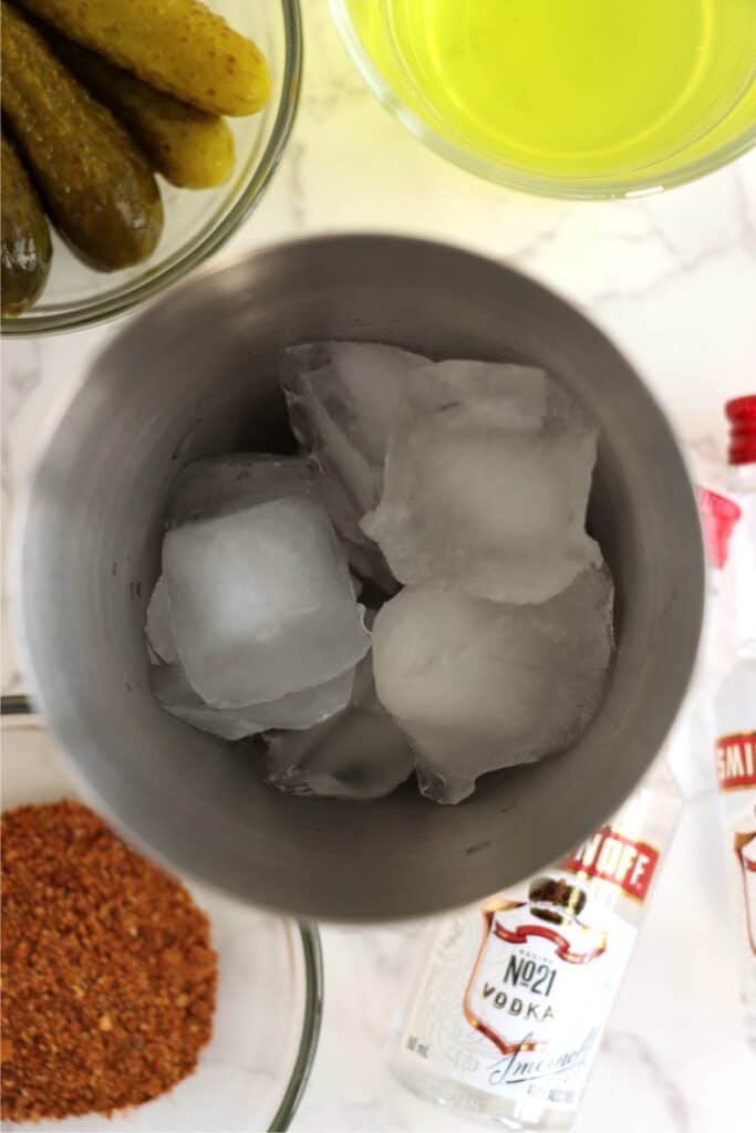 Closeup overhead shot of cocktail shaker filled with ice.