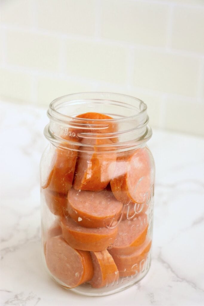 Sliced bologna in a mason jar.