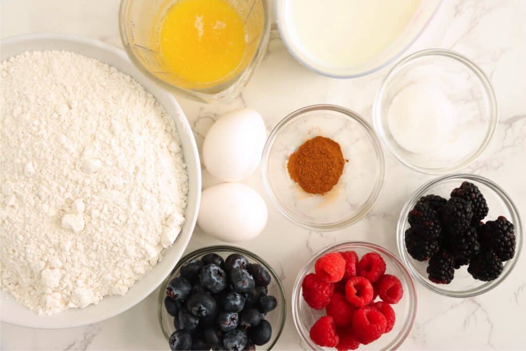 Overhead shot of individual sheet pan pancake ingredients in bowls on table. 