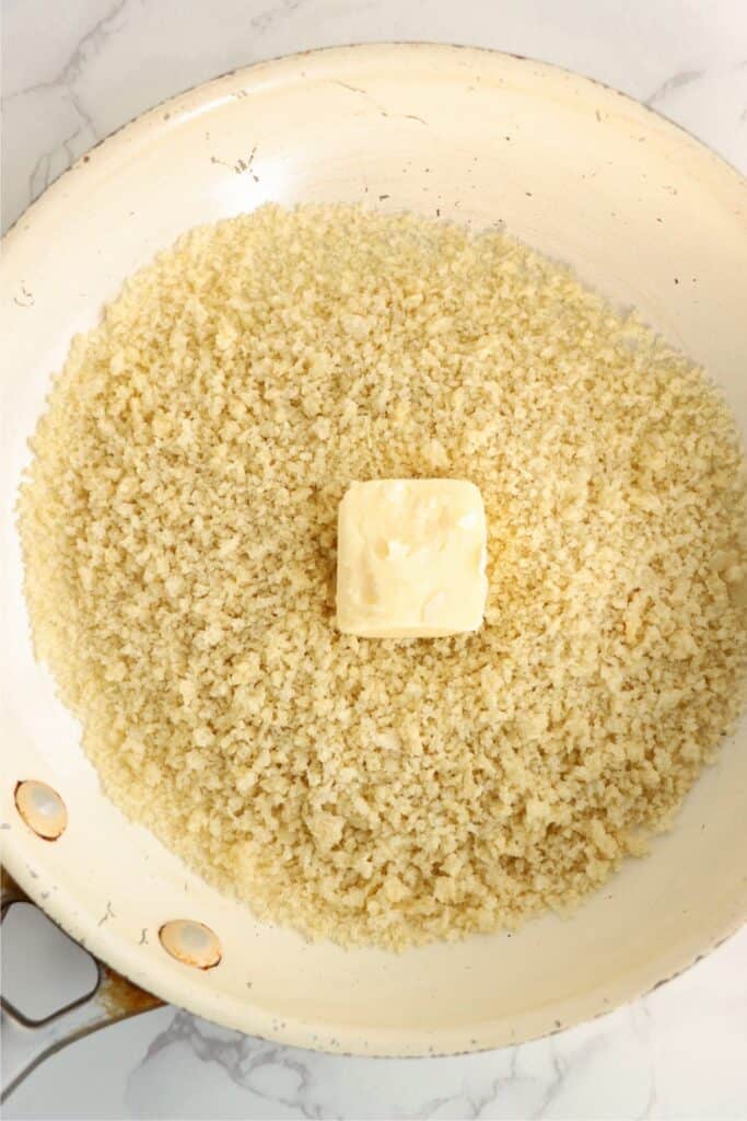 Overhead shot of pan with butter and panko. 