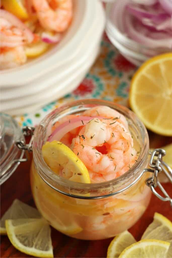 Closeup shot of pickled shrimp in jar.