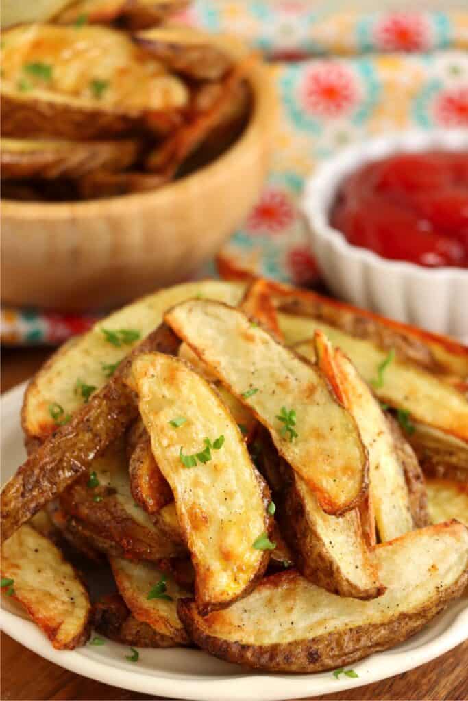 Closeup shot of plateful of seasoned air fryer steak fries. 