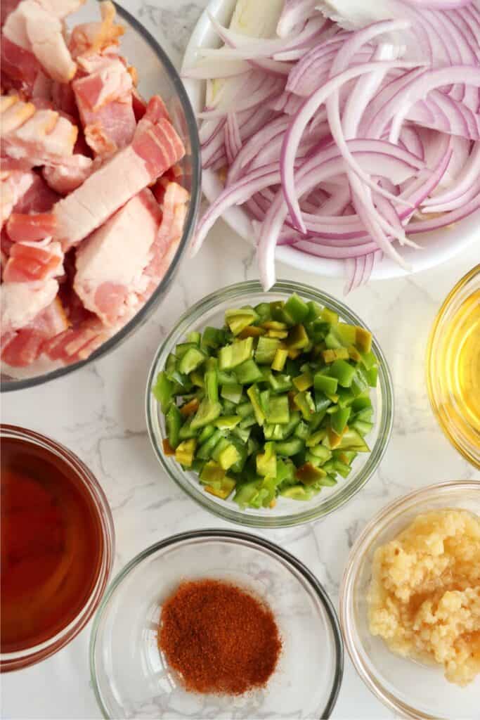 Overhead shot of individual bacon jalapeno jam ingredients in bowls on table. 