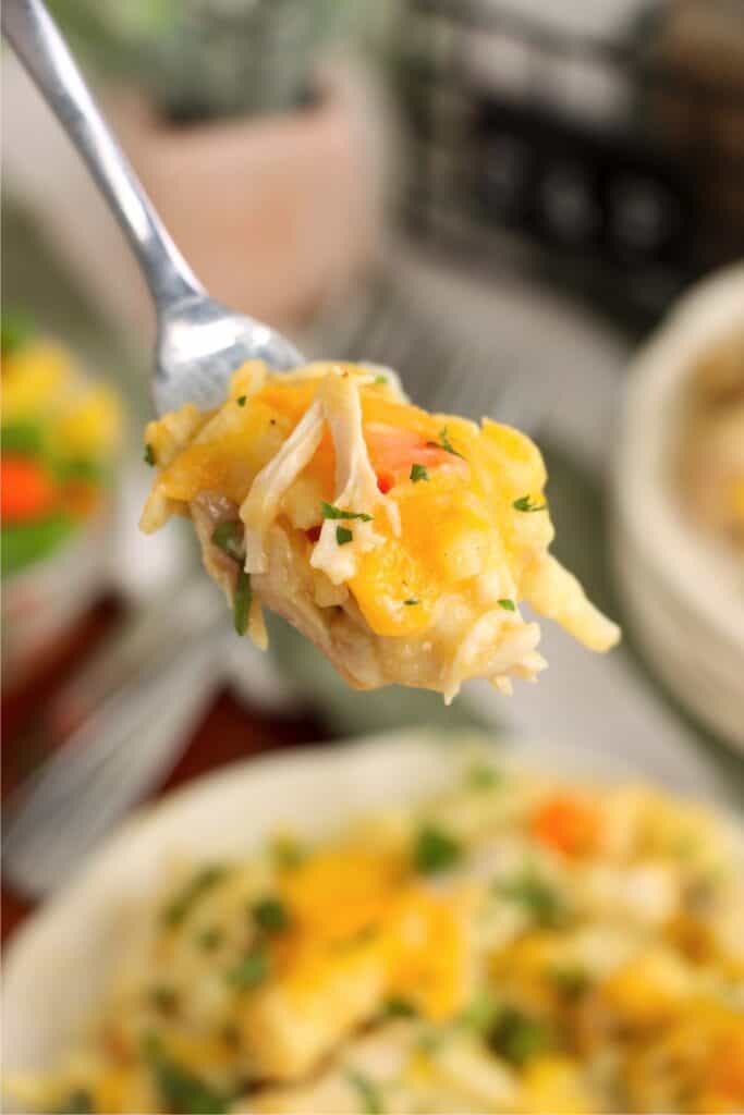 Closeup shot of forkful of chicken hash brown casserole. 