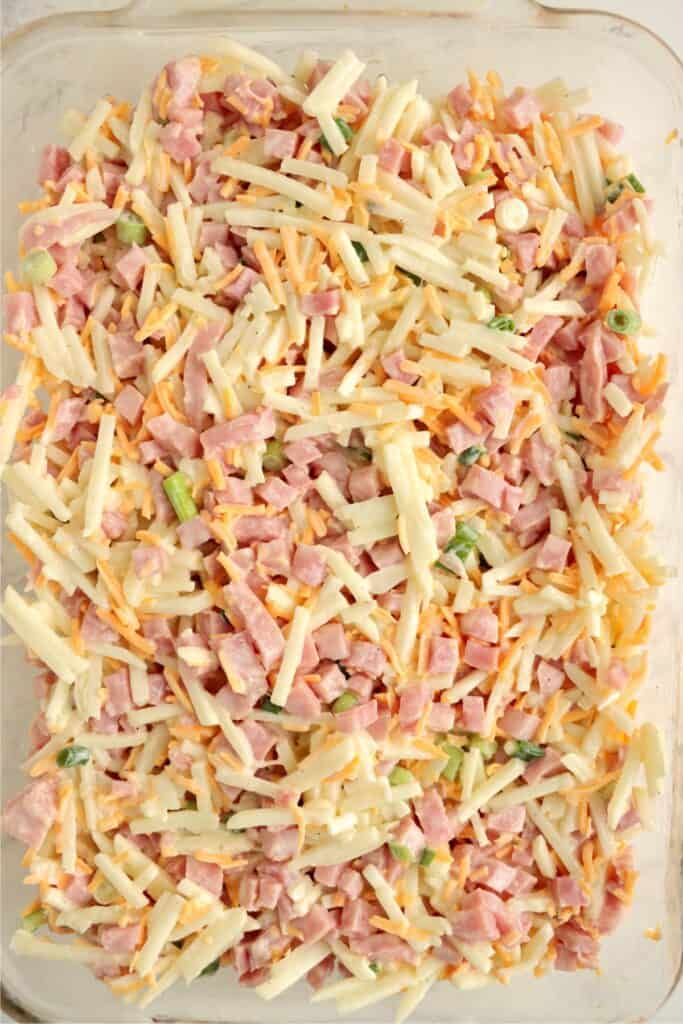 Overhead shot of mixed ham and cheese casserole in baking dish. 