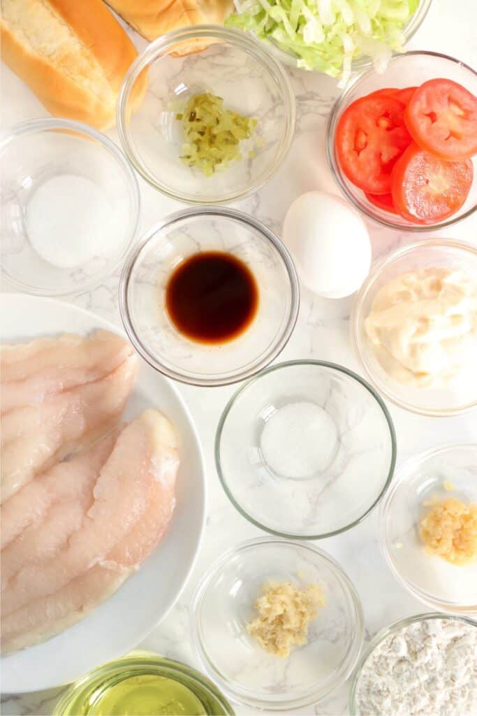 Overhead shot of individual catfish po boy ingredients in bowls on table