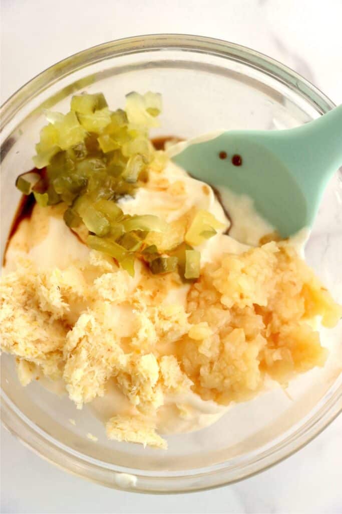 Closeup overhead shot of spicy mayo ingredients in bowl. 