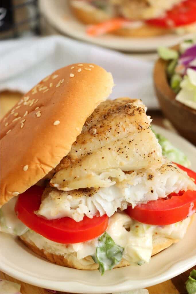 Closeup shot of catfish sandwich on plate. 