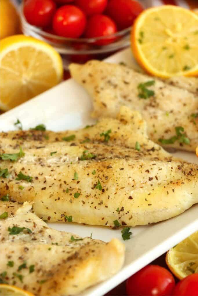 Closeup shot of catfish steaks lined up on a serving platter. 