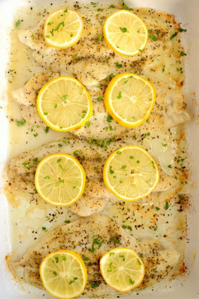 Overhead shot of baked catfish steaks in baking dish.