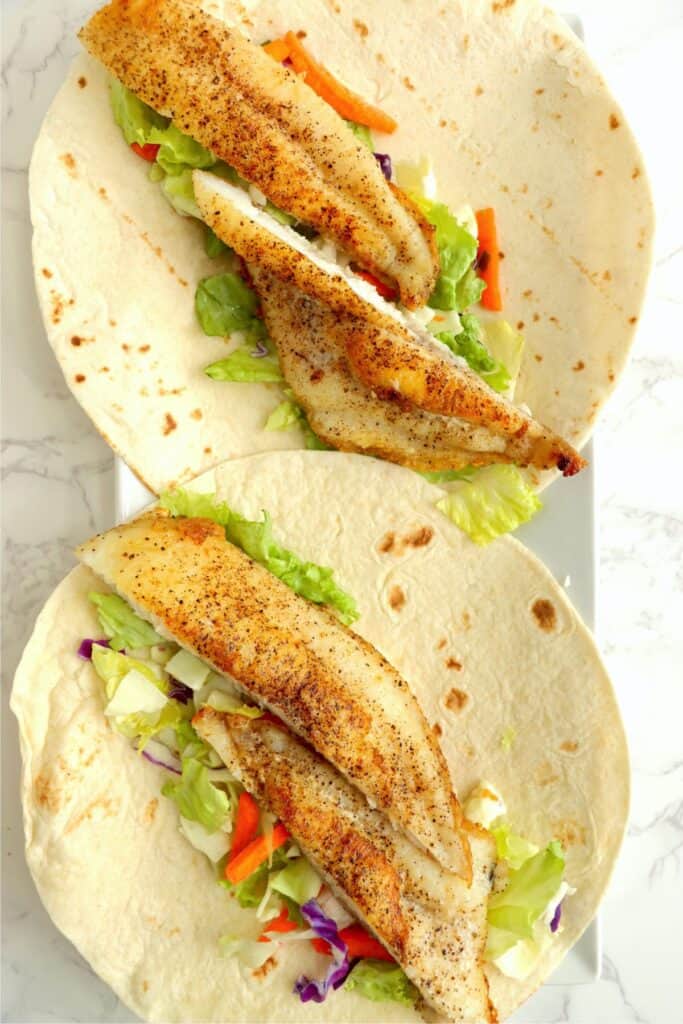 Overhead shot of two catfish tacos. 