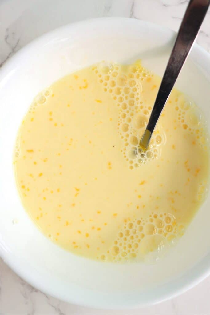 Overhead shot of bowl with milk and egg mixture. 