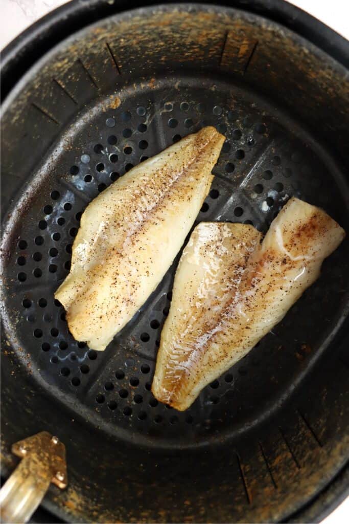 Overhead shot of air fried cod in air fryer basket