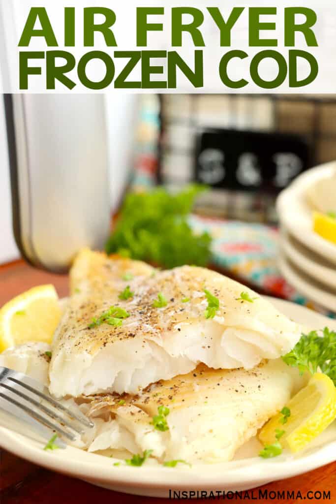Closeup shot of plate with two golden cod fillet halves stacked atop one another.