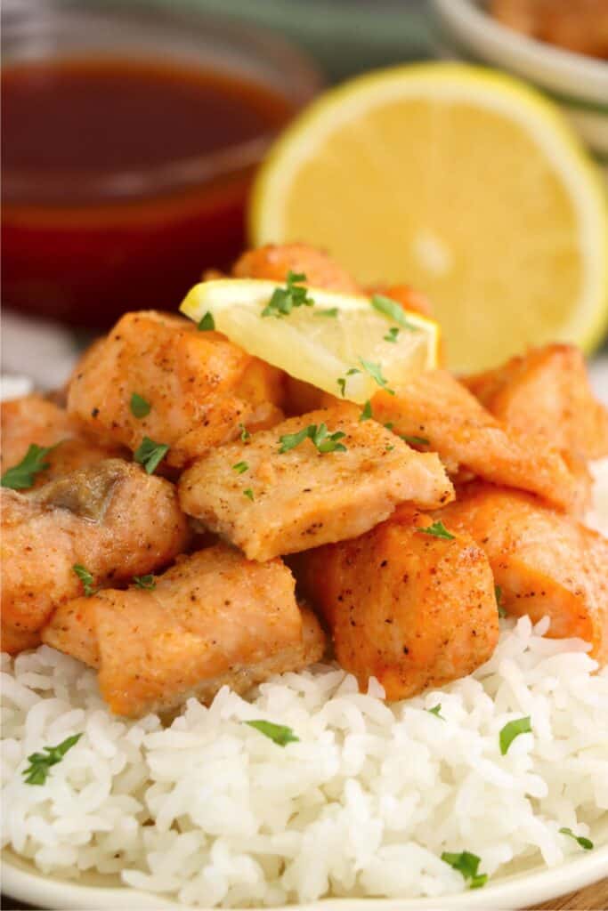 Closeup shot of air fryer salmon bites on rice. 