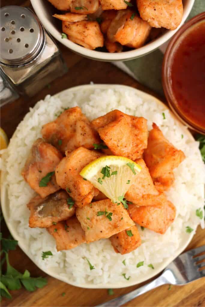 Overhead shot of air fryer salmon bites on a bed of white rice