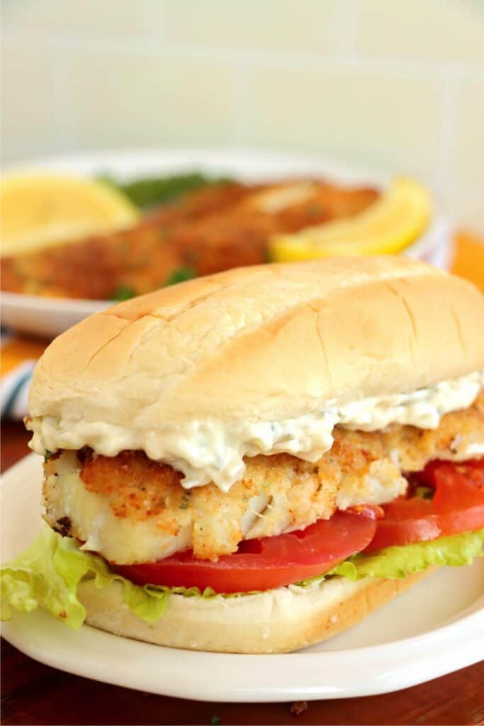 Closeup shot of cod sandwich on plate. 