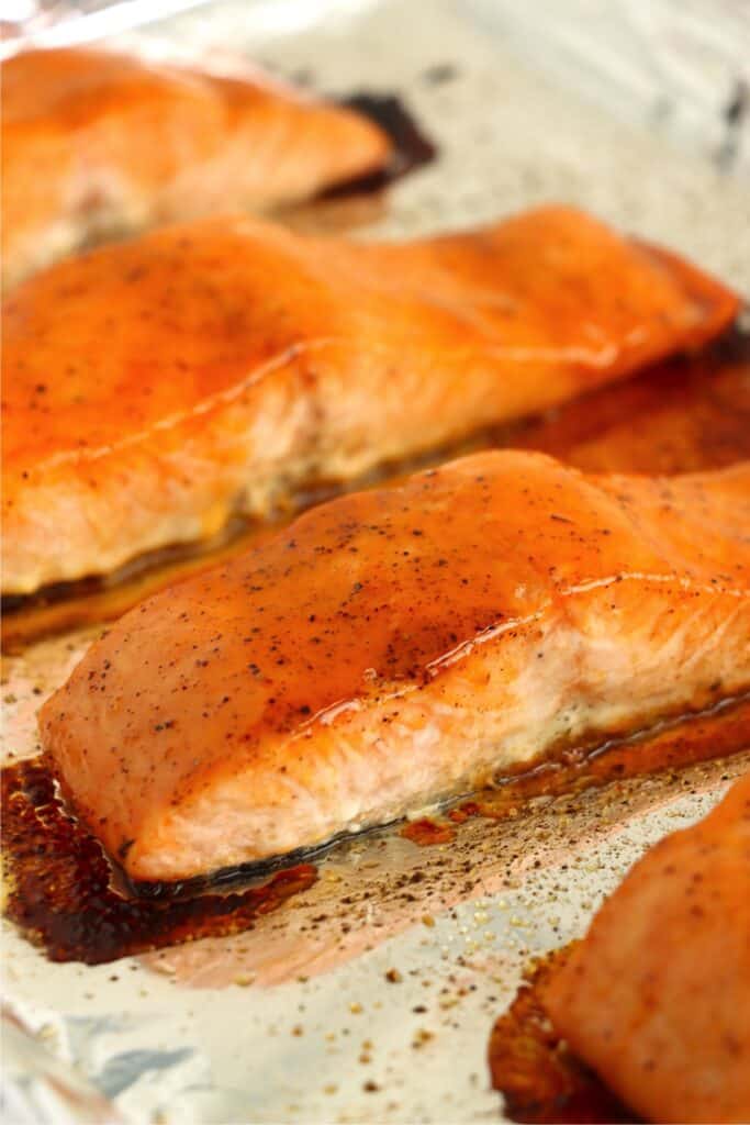 Closeup shot of hot honey salmon on baking sheet.