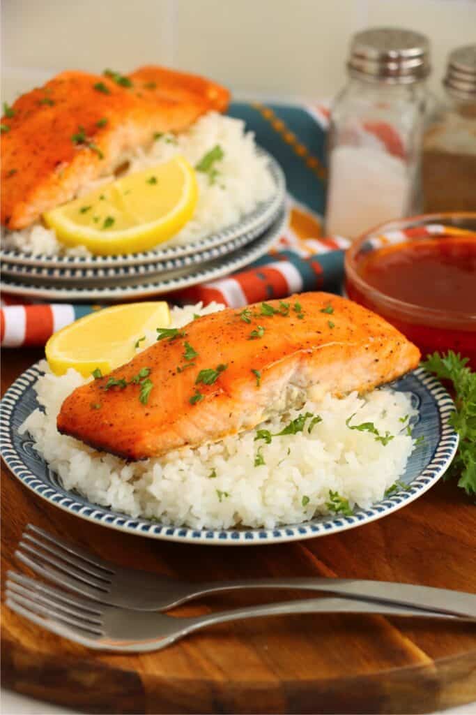 Plateful of white rice topped with hot honey salmon. 